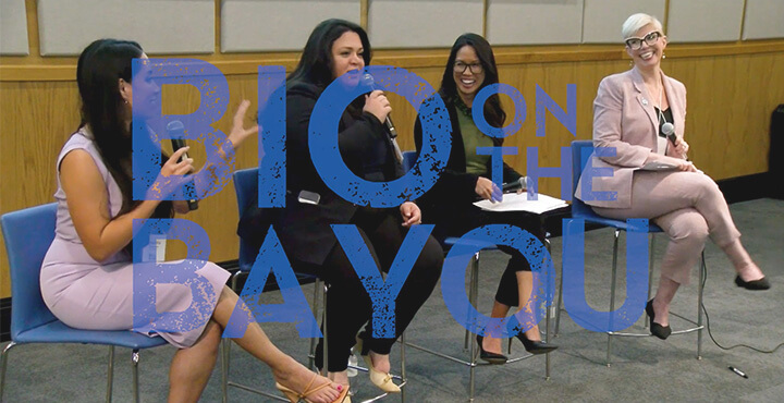 A panel discussion at the conference overlaid with the Bio on the Bayou logo